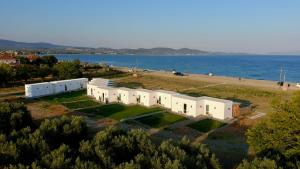 an aerial view of a building next to the water at Almond Beachfront Resort - kalyves Halkidiki in Kalives Poligirou