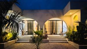 a lobby of a building with stairs and plants at Casa Mysa Villas in Michamvi