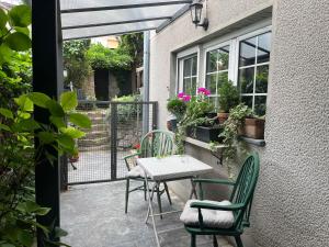 a patio with a table and chairs and a window at Magnolia Nest in Belgrade