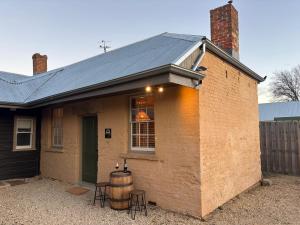 a house with a barrel on the side of it at Robinson Cottage in Oatlands