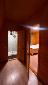 a room with a door and a bedroom with a bed at Kolsai Satu in Saty
