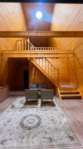 a living room with a staircase and a rug at Kolsai Satu in Saty