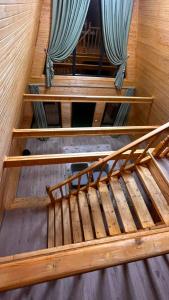 an overhead view of three wooden beds with curtains at Kolsai Satu in Saty +2 photos