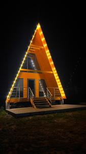 a house with a triangular roof with lights on it at Kolsai Satu in Saty