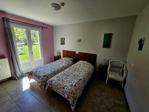 a bedroom with two beds and a window at Gite des Monges in Authon