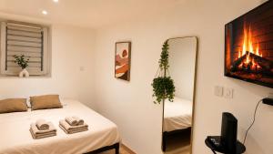 a small bedroom with a bed and a mirror at L'Adresse Mâconnaise Central - 2pers - Calme in Mâcon +1 photo