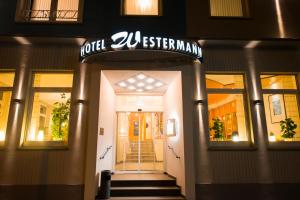 a front door of a store with a sign on it at Hotel Westermann in Osnabrück