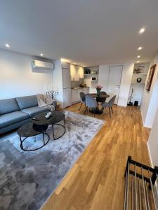 a living room with a couch and a table at Lägenhet nära badplatser, Önnered in Gothenburg +9 photos