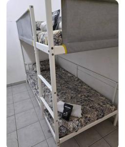 a bunk bed with a book on the bottom bunk at Pierre de lumiere in Toulouse