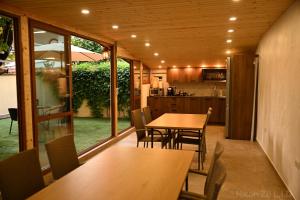 a kitchen and dining room with tables and chairs at Zlatna Ribka in Chernomorets