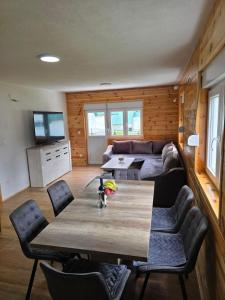a living room with a table and a couch at Mountain House 22 in Žabljak
