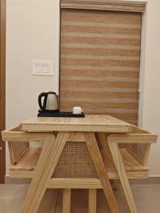 a wooden table in front of a wooden door at Ayra Inn in Cochin