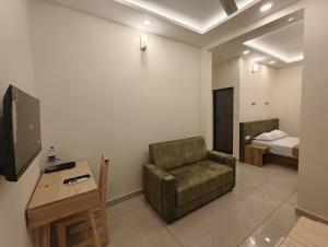 a living room with a couch and a bed at Ayra Inn in Cochin +4 photos