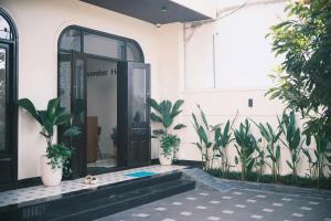 an entrance to a building with potted plants at November House in Thôn Kim Long (1)