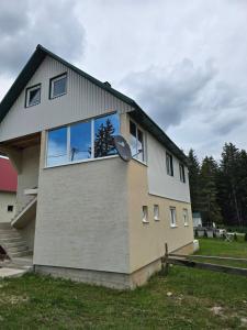 a house with a window on the side of it at Mountain House 22 in Žabljak