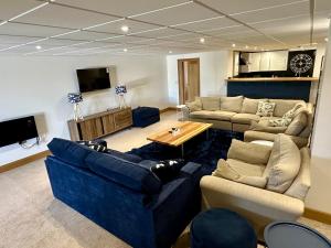 a living room with two couches and a table at Waves Guest Suites in Castel