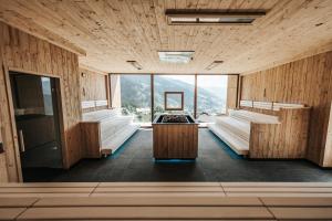 a large room with two beds and a large window at Erlebnisort Gassenhof in Ridanna +63 photos