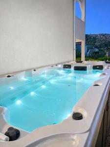 a jacuzzi tub in a building with a view at Lady A Apartment Jacuzzi Garden Outdoor Kitchen in Podglavica