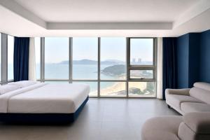 a bedroom with a bed and a large window at Sun Cloud Hotel in Busan +110 photos