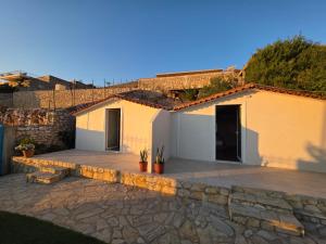 a house with a patio in front of it at Zoi's sea view in Himare
