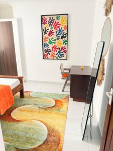 a living room with a rug on the floor and a desk at KK Homes in Diani Beach