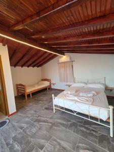 a bedroom with a bed and a wooden ceiling at Zoi's sea view in Himare