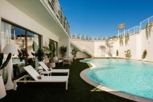 a pool in a building with chairs and a swimming pool at ARBORIS BELLI Hotel in Alberobello +53 photos