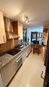 a kitchen with stainless steel appliances and a counter top at CASA COTIELLA RAÑIN in Rañín +12 photos