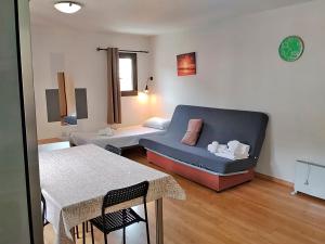 a living room with a couch and a table at Apartamentos Pantebre 3000 in Pas de la Casa