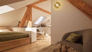a attic bedroom with a bed and a desk at Beim Julius in Immenstadt im Allgäu