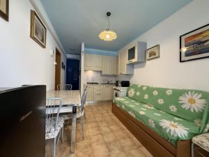 a living room and kitchen with a couch and a table at Condominio Vera Cruz in Bibione