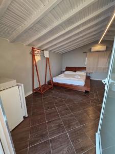 a room with a bed and a tiled floor at Zoi's sea view in Himare +15 photos