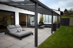 a patio with two chairs and a couch on a patio at Bellalaens in Zemst