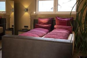 a bed with four pillows on it in a room at Bellalaens in Zemst