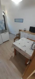 a room with a wooden table and a table with at Marijana - One bedroom with balcony in Babino Polje +14 photos