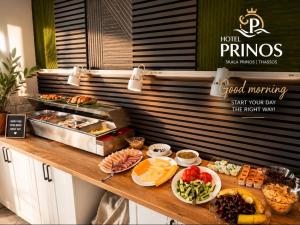 a buffet line with different types of food on it at Hotel Prinos in Skala Prinou