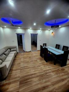 a living room with a couch and a dining room table at Hazy hill in Mussoorie +37 photos