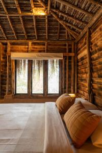 a bedroom with a large bed with pillows on it at The Mudhouse Marayoor in Munnar