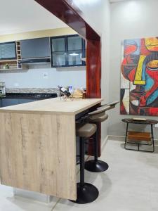 a kitchen with a bar with a dog sitting on top of it at Ednomis Apartment in Mazabuka +7 photos