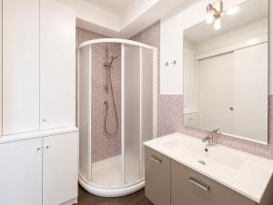 a white bathroom with a shower and a sink at Porta Nuova Studio - Sostify in Bergamo