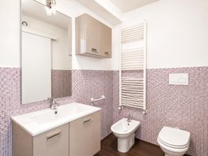 a bathroom with a sink and a toilet and a mirror at Porta Nuova Studio - Sostify in Bergamo