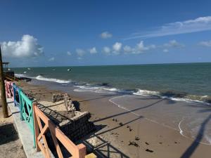 a beach with birds on the sand and the ocean at Cantinho Muriu in Ceará-Mirim