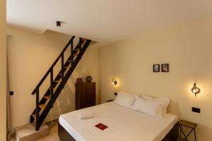 a bedroom with a bed and a staircase at L'ateneo Lumiére in Agrigento