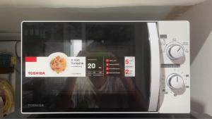 a microwave oven with a sign inside of it at Mood Resotel Kamala in Kamala Beach
