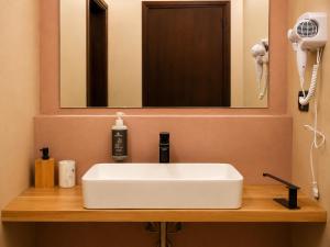 a bathroom with a white sink and a mirror at Antico Monastero del Lavello in Calolziocorte +24 photos