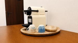 a counter with a coffee maker and mugs on a table at Antico Monastero del Lavello in Calolziocorte