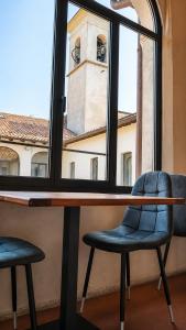 two chairs sitting at a table in front of a window at Antico Monastero del Lavello in Calolziocorte