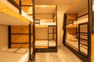 a room with bunk beds in a hostel at Cafe Moto Hostel in Puerto Princesa City +158 photos