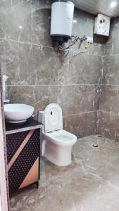 a bathroom with a toilet and a sink at Hazy hill in Mussoorie