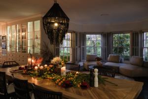 a living room with a table with flowers and candles at Wayside Zenhill Retreat Bowral Event & Farm in Glenquarry